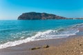 Wave on the beach and beautiful view to ancient fortress on the Royalty Free Stock Photo