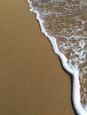 Wave and beach sand closeup