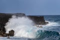 Wave on Black Sand Beach, Big Island, Hawaii. Volcanic Cliffs in background Royalty Free Stock Photo