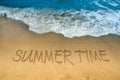 Wave of blue sea on sandy beach. The text Summer Time written in the sand. amazingly beautiful sea landscape with Summer Word Royalty Free Stock Photo