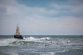 Wave board surfers and lighthouse Royalty Free Stock Photo