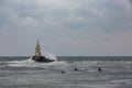 Wave board surfers and lighthouse Royalty Free Stock Photo