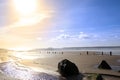 Wave breakers at sunset on a golden rocky beach Royalty Free Stock Photo