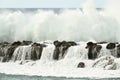 Wave Breaking above Rock Wall on Clear Day