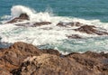 A wave breaking against a rock in the sea Royalty Free Stock Photo