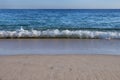 Wave breaking by the beach at the Portinho da Arrabida beach in Portugal