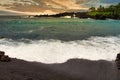 Frothy white wave breaking on Wainapanapa Beach on Maui.