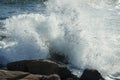 Wave breaking on rocks Royalty Free Stock Photo