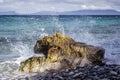 A wave breaking into spray on a large stone! Royalty Free Stock Photo