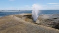 A wave breaks at the blowhole in bicheno, tasmania