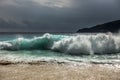 Wave breaks on the sandy shore