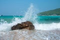 Wave crash against the rocks during a storm in the tropics