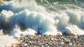 A wave crashes onto a sandy beach, creating a dramatic and forceful display of natures power, Ocean shore with rolling waves and