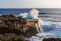 Wave crashing against cliff, Devil Tear, Nusa Lembongan. Pool on top of cliff. Oean, sky behind. Royalty Free Stock Photo