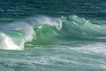 Wave crashing against rocks on the beach Royalty Free Stock Photo