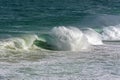 Wave crashing against rocks on the beach Royalty Free Stock Photo