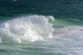 Wave crashing against rocks on the beach Royalty Free Stock Photo