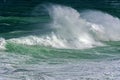 Wave crashing against rocks on the beach Royalty Free Stock Photo