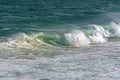 Wave crashing against rocks on the beach Royalty Free Stock Photo