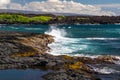 Black sand beach, wave crashing on black rocks. Big island of Hawaii. Royalty Free Stock Photo