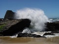 Wave Crashing Over Rocks On Sandy Beach Blue Sky Royalty Free Stock Photo