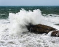 Wave crashing on rock by a stormy day Royalty Free Stock Photo