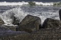 Wave crashing on sea defence rocks. Force of nature