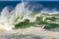 Wave crashing during stormy weather on a sunny day Royalty Free Stock Photo