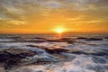 The wave flows over weathered rocks and boulders at North Narrabeen Royalty Free Stock Photo