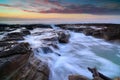 Wave flows over weathered rocks and boulders