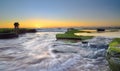 The wave flows over weathered rocks and boulders at Turimetta Be Royalty Free Stock Photo