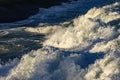 Wave foam advancing on the rocks Royalty Free Stock Photo