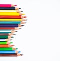 Wave gesture of a line of different color wood pencil crayon on a white background