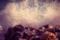 Wave hit the rock at the beach, sea water splash spray up at sunset Royalty Free Stock Photo