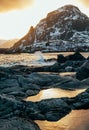 Wave hiting rocks at sunset