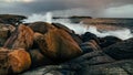 Wave hiting rocks at sunset