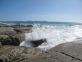 Wave hitting Australian rocky coast and beach with giant rocks