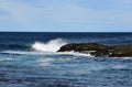 Wave hitting a rock in the ocean making a big splash Royalty Free Stock Photo