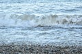 A wave moving across the sea to the beach