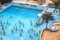 Wave pool in the water park. Numerous visitors swimming in the p