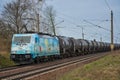 Wave rider locomotive with blue and black wagons passing through Saarmund, Germany