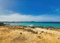 Wave and sand beach background. Empty beautiful beach with azure water, forgotten flip flops. Tropical sea under the blue sky. Royalty Free Stock Photo