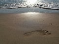Wave on the sand beach - footprint Royalty Free Stock Photo