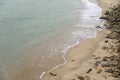 Wave on the sand beach with stones