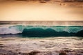 Wave in the sea breaking over during sunset. Close-up of a large wave as it flips over. Ocean view at sunset from Bali. 2022 Royalty Free Stock Photo