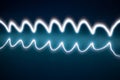 Wave shaped light painting with long exposure trails in cool blue colours