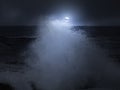 Wave splash in a cloudy full moon night Royalty Free Stock Photo