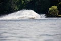 Wave and splash of water is covering the entire jet ski that is making it