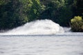 Wave and splash of water is covering the entire jet ski that is making it