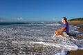 Wave splashes on meditating young man Royalty Free Stock Photo